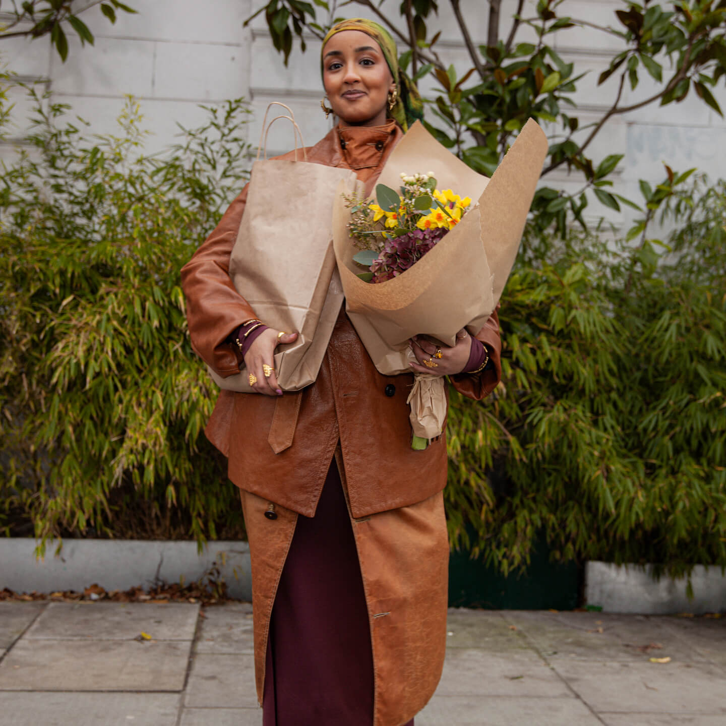 A person holding flowers outdoors